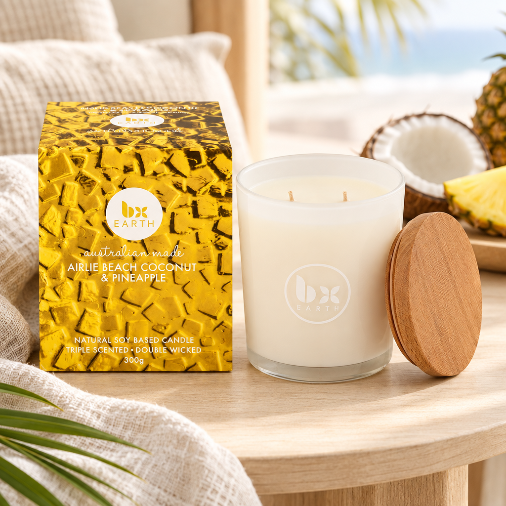 Airlie Beach coconut and pineapple candle on a pale timber table in a softly lit coastal room