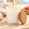 BX Earth Riverina Watermelon and Buttercream candle burning with two wicks in a frosted glass jar.