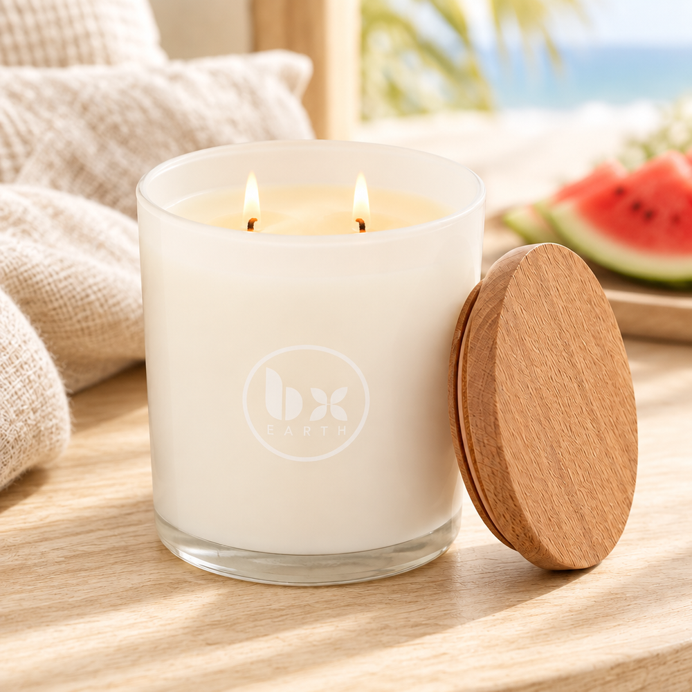 BX Earth Riverina Watermelon and Buttercream candle burning with two wicks in a frosted glass jar.